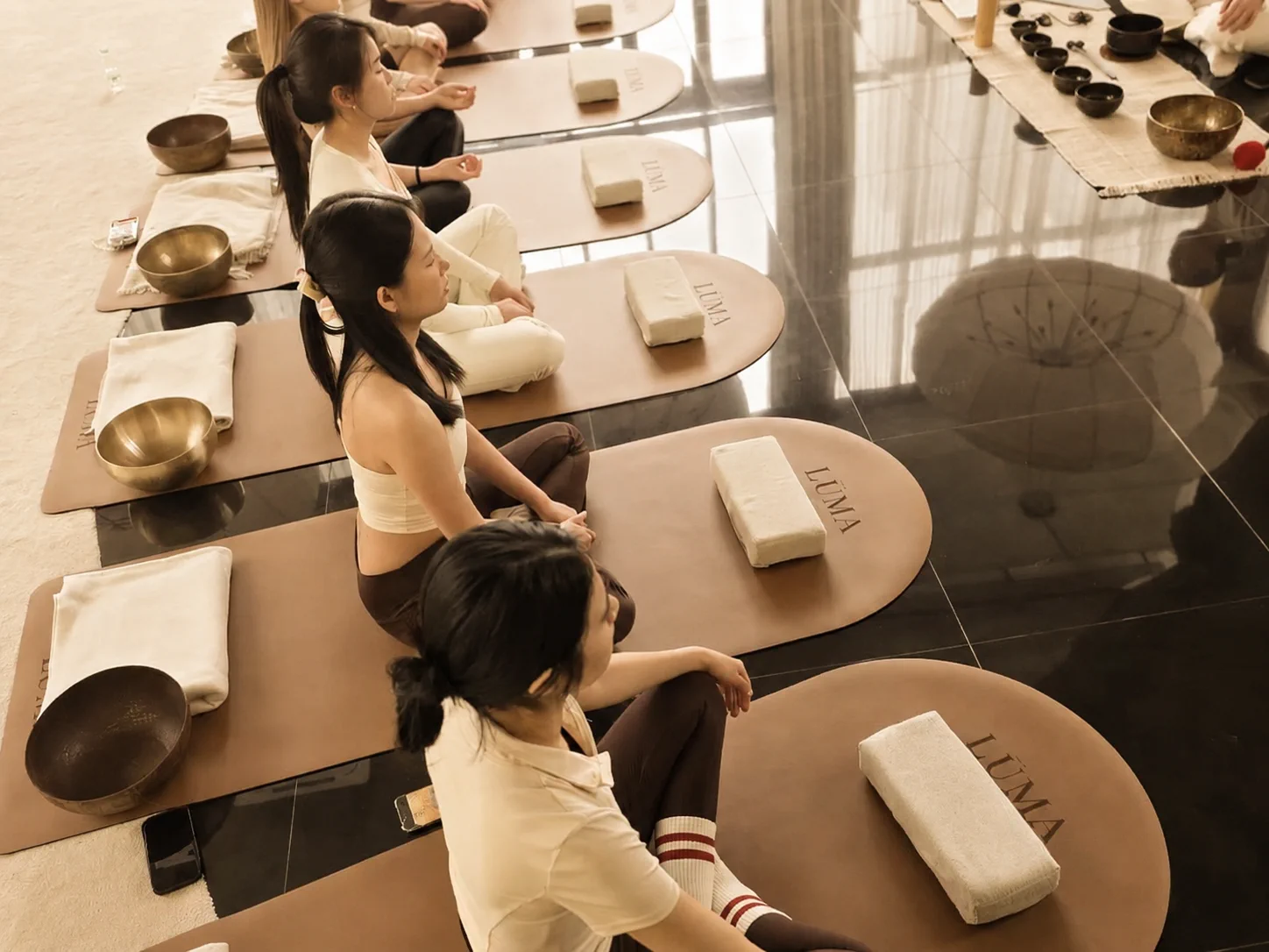 Members settling into a shared sound meditation ritual