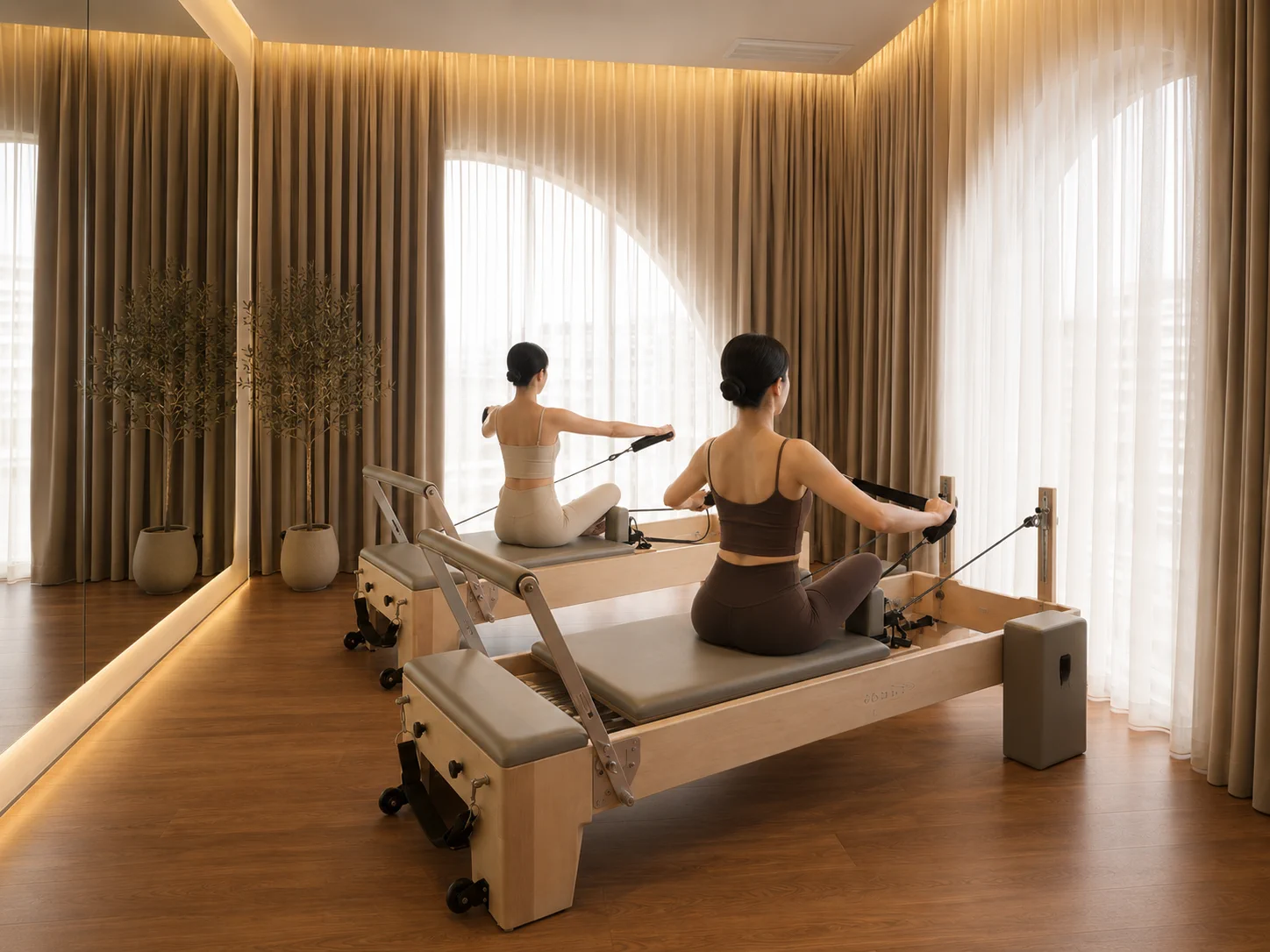 Two members moving together in the reformer studio
